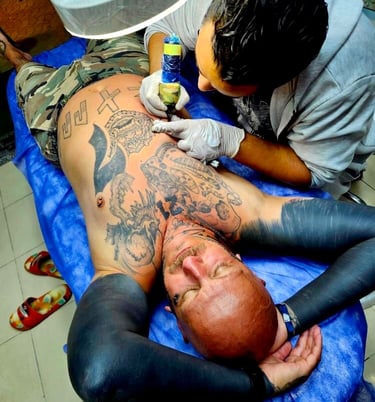 Tattoo artist working on client arm in Hurghada”