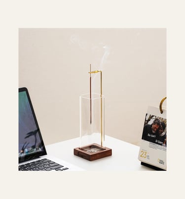 picture of an upside down incense burner with a glass and wooden holder