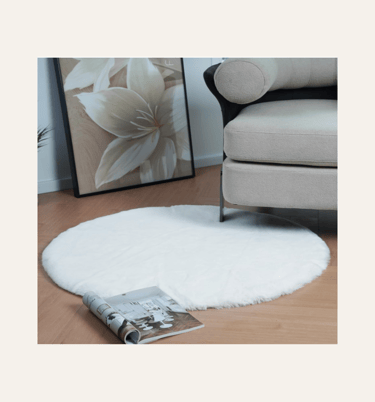 a picture of a round faux rabbit fur rug in front of an armchair