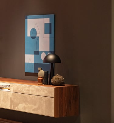 a modern console table with a lamp and a painting