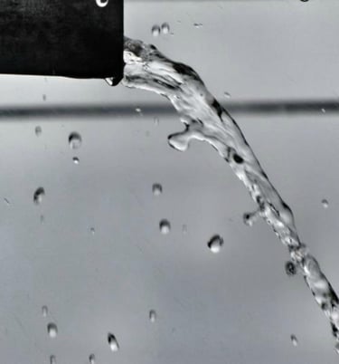 a black and white photo of a water fountain