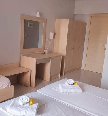 a bedroom with two beds and a desk