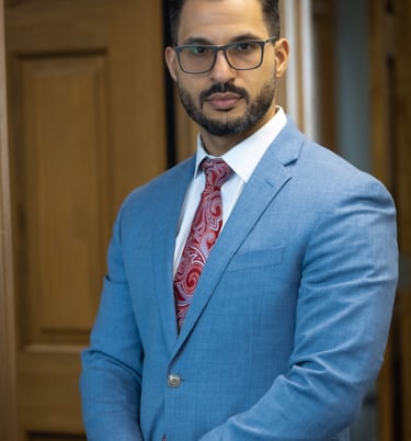 a man in a blue suit and red tie