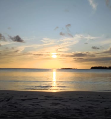 a boat is sailing on the water at sunset