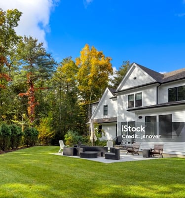 a large backyard with a fire pit and a patio