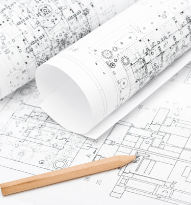 Various rolls of draft paper with schematic drawings and a single sharp pencil.