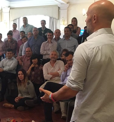 a man standing in front of a crowd of people MARTIN PE / COACH