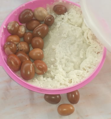 shea nuts and shea butter in a  pink bowl