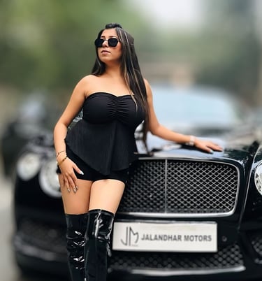 a woman in a black dress and boots is posing for a picture