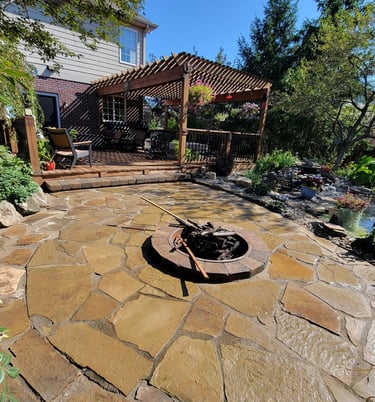 Custom flagstone patio and firepit installed for a customer by Kingdom Landscape