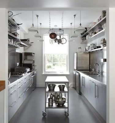 Modern home kitchen featuring a central mobile stainless steel island and custom benchtops from the About SSB team.