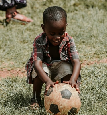 A young boy playing football