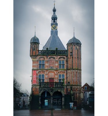 Photograph of a traditional Dutch building in front of a looming grey sky.