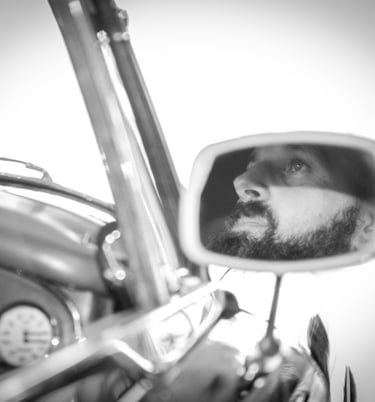 a man with a car and a car in a mirror