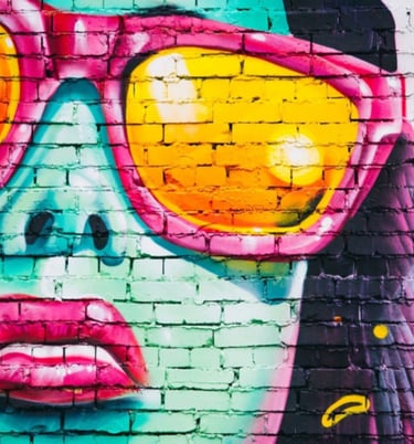 Graffiti brick wall with painting of girl with sunshades