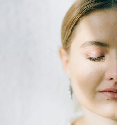 Woman with eyes closed half of face shown