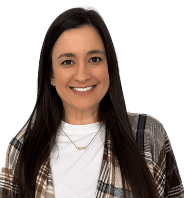 woman with long dark hair wearing a white shirt and plaid scarf