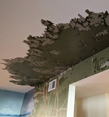 Ceiling and wall mural of a mangrove tree around a hallway entrance.
