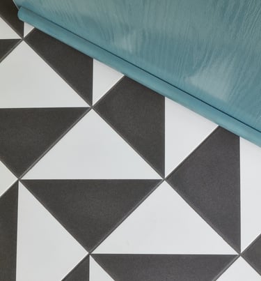 black and white geometric floor tile with a blue front door