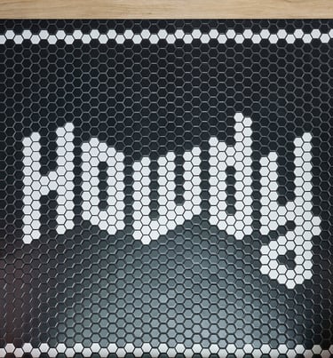 Black and white mosaic tiles with the word howdy in the design