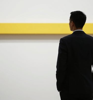 A professional silhouette of a person standing against a clean wall with a yellow accent beam, reflecting forward-thinking leadership.
