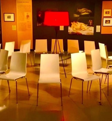 a circle of chairs with chairs and lamps