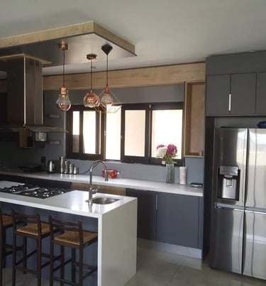 a kitchen with a stove top and a refrigerator