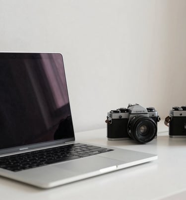 A minimalist workspace with a modern laptop and a vintage film camera, off-white walls, North American / US home office style, clean and professional.
