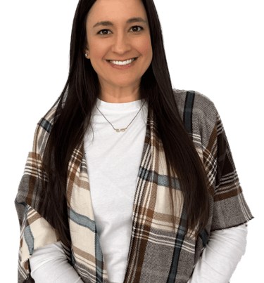 woman with long dark hair wearing a white shirt and plaid scarf
