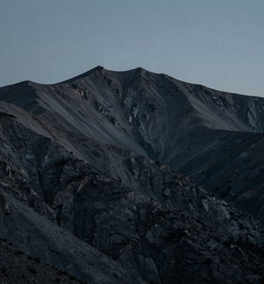 A minimalist North American / US mountain landscape at dusk, dark slate and teal gray tones, sophisticated and calm atmosphere, professional nature photography.