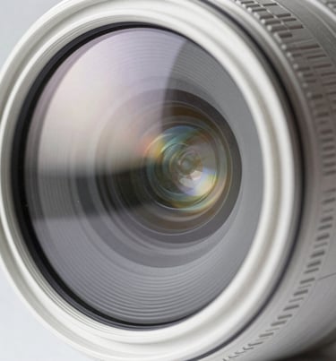 Abstract photography of light reflecting on a lens, creating subtle flares, clean and modern aesthetic, white and light gray tones, professional style.