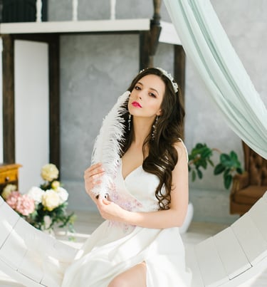 a woman in a white dress sitting on a circular object