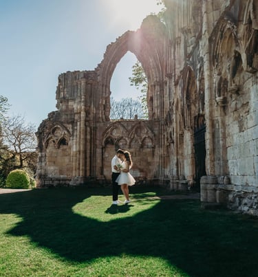 Bride standing near historic stone ruins in York, photographed by Fred Art Studio.