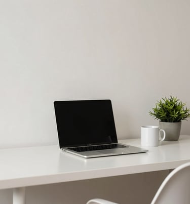 A minimalist workspace in a South American / Brazilian home office, featuring a laptop, a coffee mug, and a small green plant, crisp off-white and soft pale blue tones.