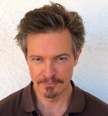 Headshot of Todd Long with medium-short hair, moustache, and goatee