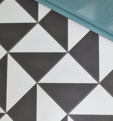 black and white geometric floor tile with a blue front door