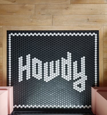 Black and white mosaic tiles with the word howdy in the design