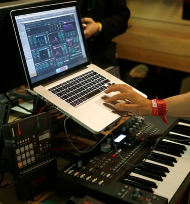 a person is using a laptop computer and a keyboard