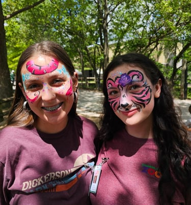 two girls with painted face paint on their faces
