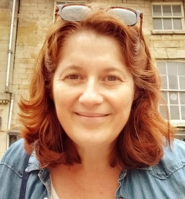 a head shot of the owner of Kemend wearing sunglasses on the top of her head