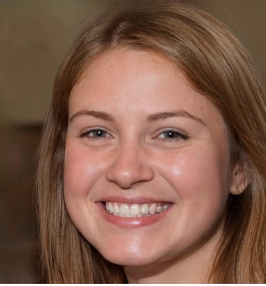 A smiling young woman with light brown hair and green eyes posing for a portrait headshot.