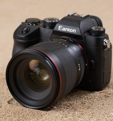 A close-up of professional camera equipment resting on a textured Soft Sand fabric. The lighting is soft and cinematic, highlighting the glass of the lens. Authentic lifestyle photography gear shot.