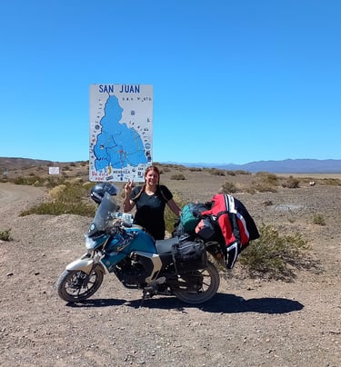 a woman standing next to a motorcycle with a map of the world