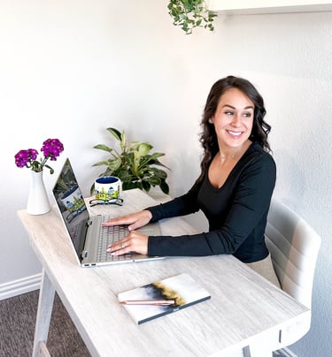 Professional writer at writing at a desk and smiling