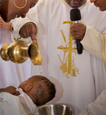 a priest and a baby in a priest's robes