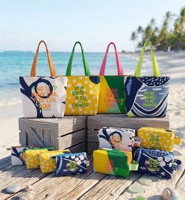 Colorful beach tote bags and matching pouches with Spanish text on a tropical sandy beach.
