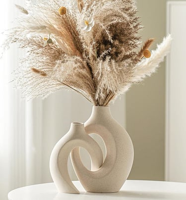 Modern ceramic vase set of 2 styled with dried pampas grass on a table, featuring neutral home decor in minimalist interior.