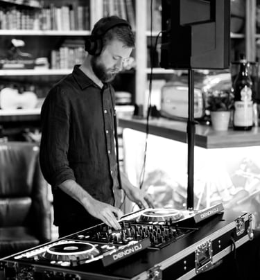 a man in a black shirt and a dj controller
