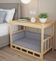A wooden bedside table with a built-in dog bed featuring a grey plaid cushion next to a modern bed.