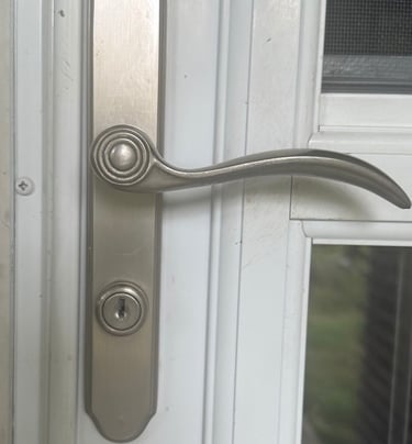 Residential door handle and lock on a white exterior door